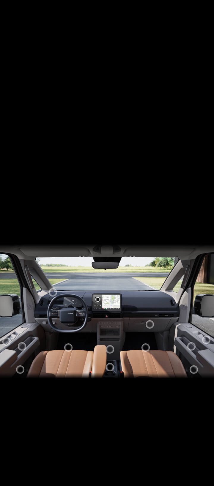 Vordere Innenansicht des Kia PV5-Passagiers mit zahlreichen versteckten Ablagefächern im Fahrer- und Beifahrerbereich